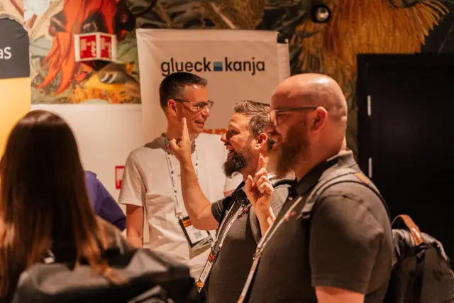Attendees talking with a sponsor at their booth during Workplace Ninjas Norway 2026