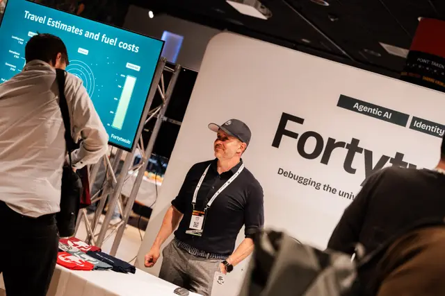 An attendee visiting a sponsor stand in the expo area at Workplace Ninjas Norway 2026