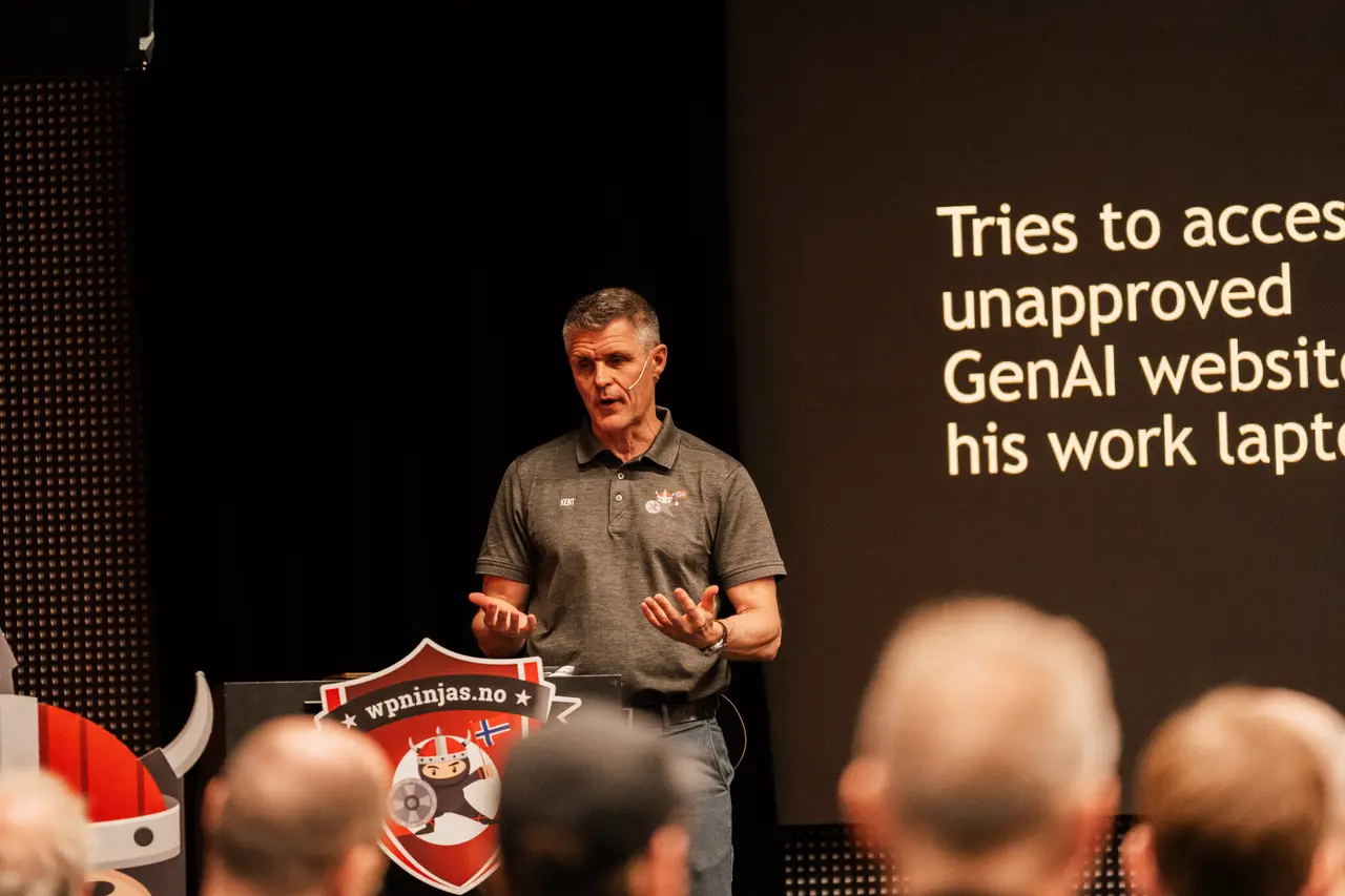 A speaker presenting to the audience from the Workplace Ninjas Norway stage in 2026