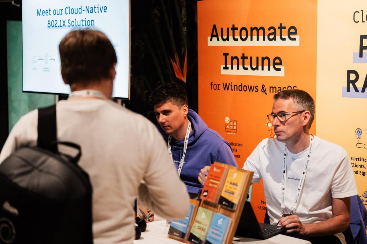 Attendees in conversation with sponsors at their booth during Workplace Ninjas Norway 2026