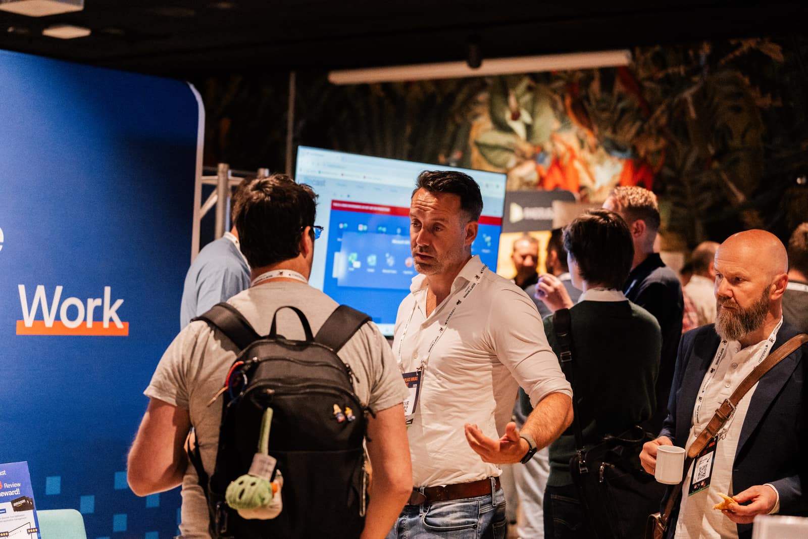 Attendees talking with sponsors in the expo area at Workplace Ninjas Norway 2026