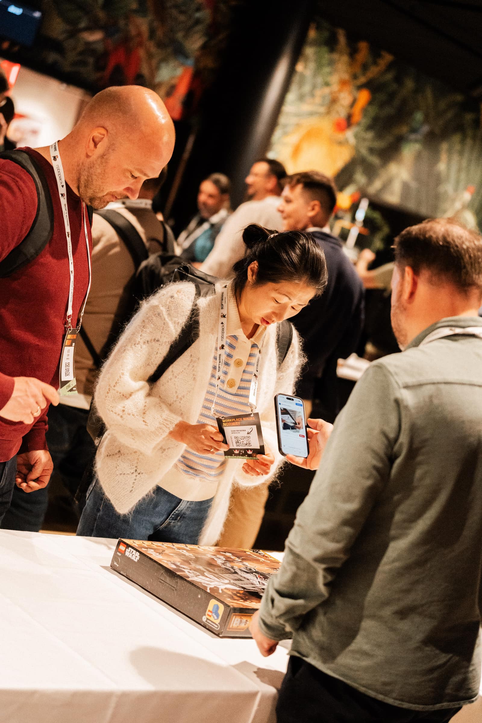 Attendees scanning their badge at a sponsor booth during Workplace Ninjas Norway 2026